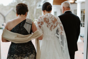 Bride walking with parents